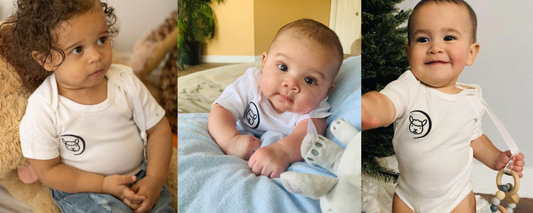 Various babies wearing Lamsie Baby Bodysuits with pacifier straps