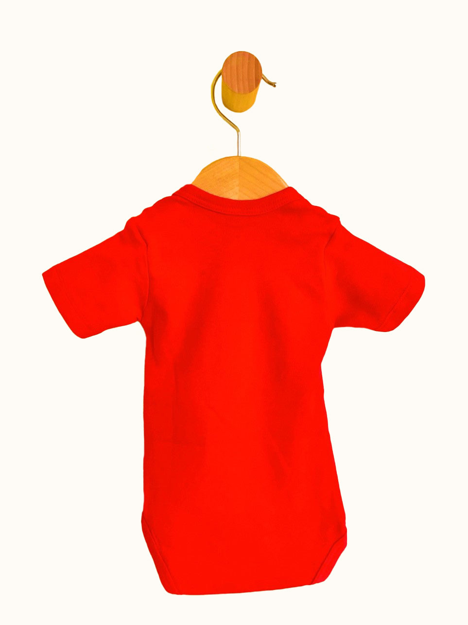 Back view of red short sleeve Baby Bodysuit with pacifier strap and snap crotch